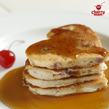 Fluffy stack of heart shaped cherry and ricotta cheese pancakes.