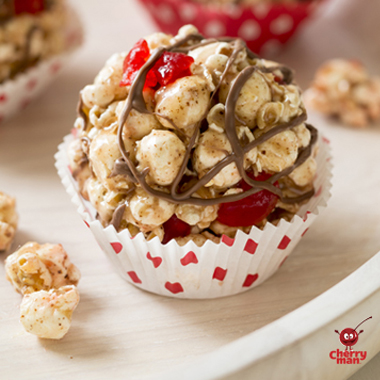 Cherry chocolate popcorn balls drizzled in chocolate.