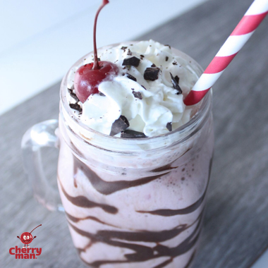 A stack of chocolate cherry cookies served with cold milk. 