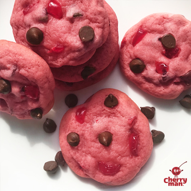 A stack of chocolate cherry cookies served with cold milk. 