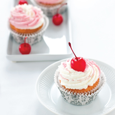 Cherry cupcake topped with buttercream frosting