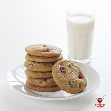 glass of milk and cherry chocolate chip cookies