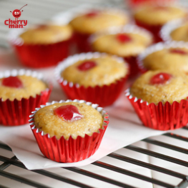 Maraschino cherry chia mini muffins on bakers rack. 