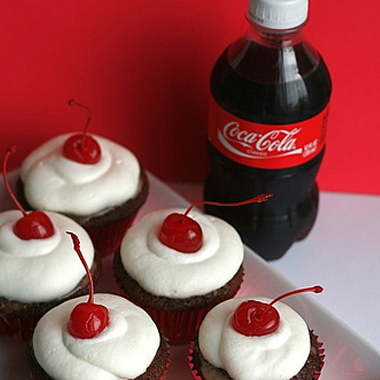cherry coke cupcakes with whipped topping and cherry.