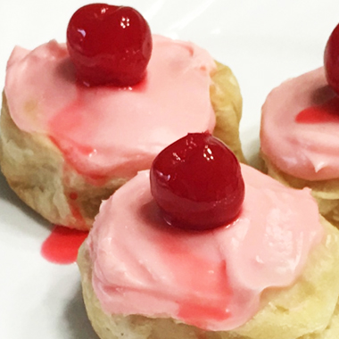 Single chocolate cherry bomb served on white plate