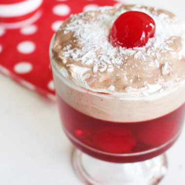 A stack of chocolate cherry cookies served with cold milk. 