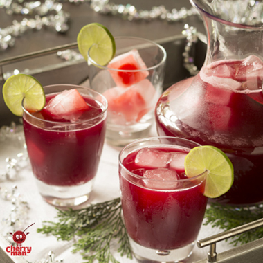 Cherry punch served in glasses with holiday garland and greenery.