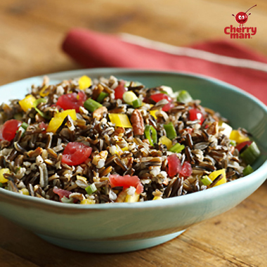 Wild rice salad in blue dish with maraschino cherries 